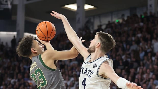 Feb 26, 2022; Logan, Utah, USA; Colorado State Rams guard Isaiah Rivera (23) shoots around Utah State Aggies forward Brandon Horvath (4) in the first half at Dee Glen Smith Spectrum. Mandatory Credit: Rob Gray-USA TODAY Sports